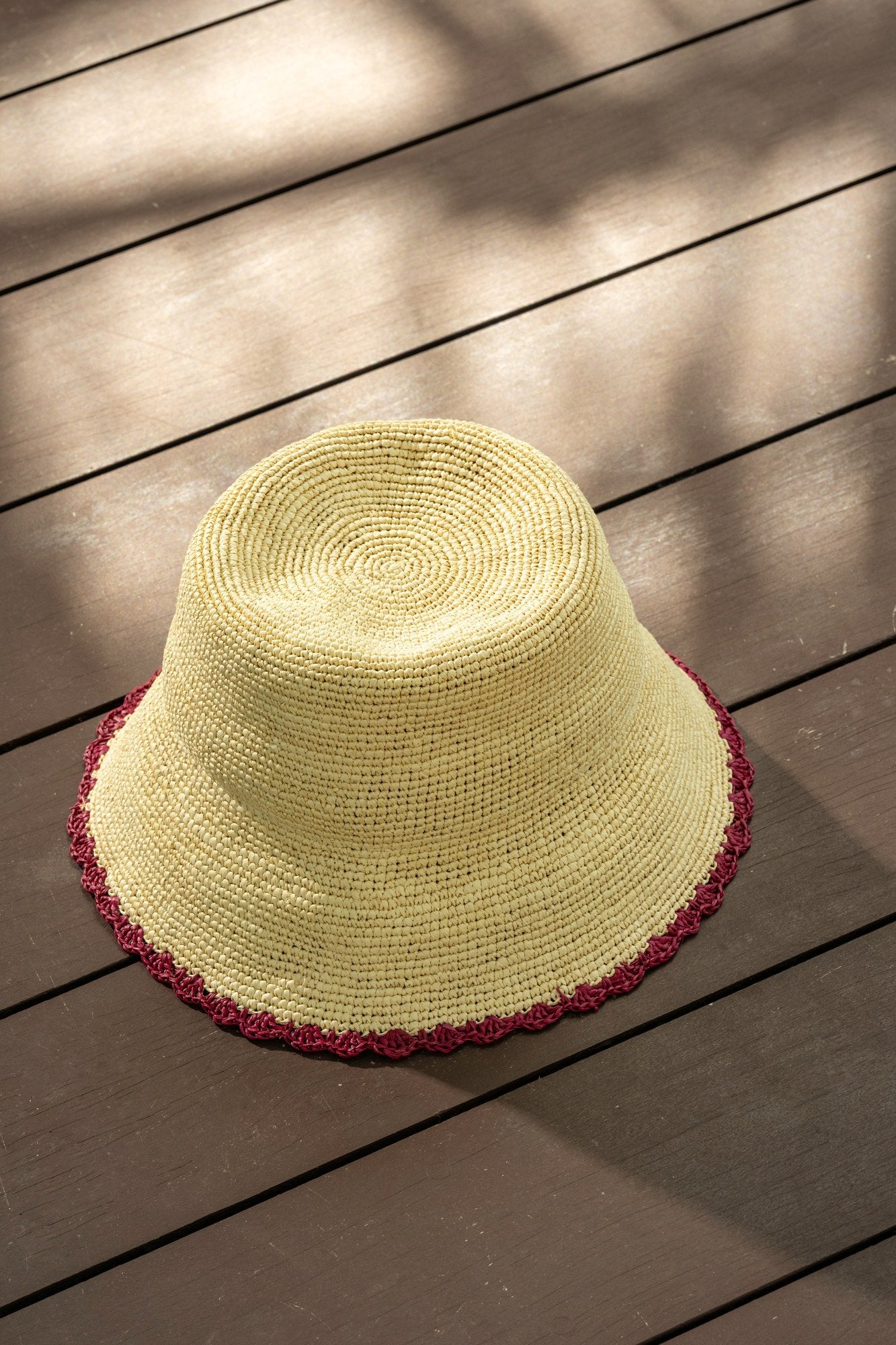 Sierra bucket hat in burgundy — handwoven toquilla straw with a scalloped burgundy trim